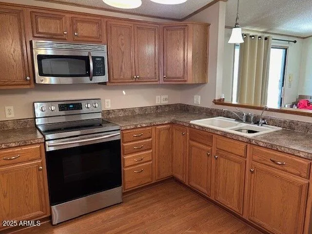a kitchen with granite countertop a sink and steel appliances