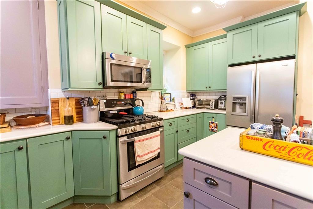 5901 Hampton Street Pittsburgh, PA 15206 - Photo 12 of 42 a kitchen with a sink a stove and cabinets