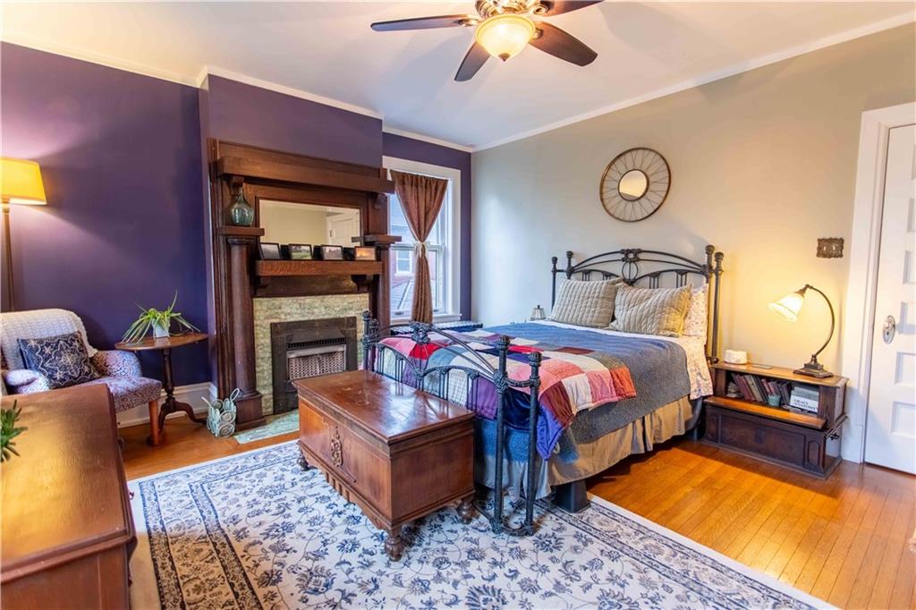 5901 Hampton Street Pittsburgh, PA 15206 - Photo 15 of 42 a spacious bedroom with a bed a chandelier and closet