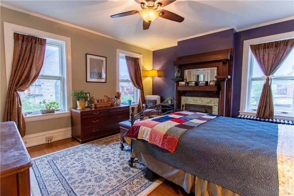 5901 Hampton Street Pittsburgh, PA 15206 - Photo 16 of 42 a bedroom with a bed and wooden floor