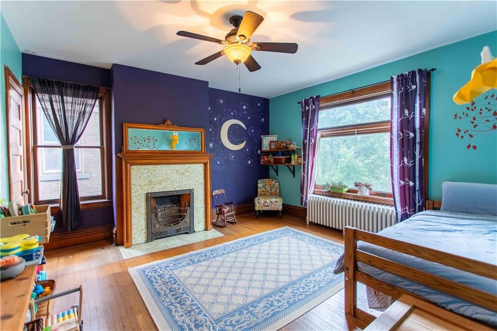 5901 Hampton Street Pittsburgh, PA 15206 - Photo 18 of 42 a living room with furniture a window and a fireplace