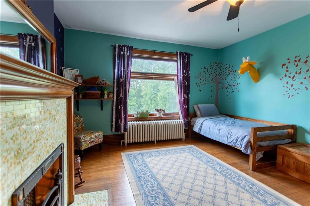 5901 Hampton Street Pittsburgh, PA 15206 - Photo 19 of 42 a bedroom with furniture and a window