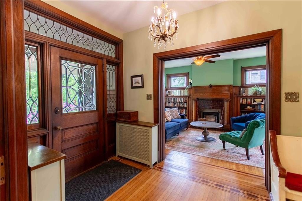 5901 Hampton Street Pittsburgh, PA 15206 - Photo 2 of 42 a living room with furniture a window and a fireplace