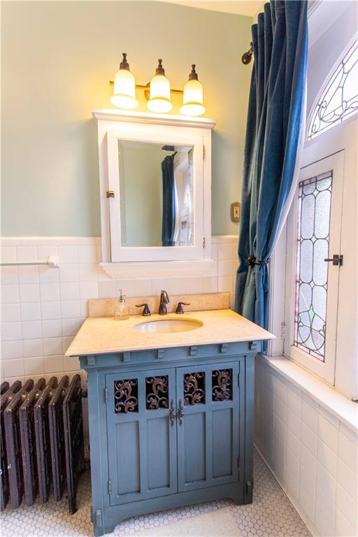5901 Hampton Street Pittsburgh, PA 15206 - Photo 26 of 42 a bathroom with a sink and a mirror