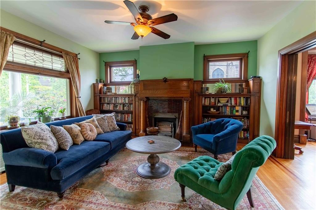 5901 Hampton Street Pittsburgh, PA 15206 - Photo 4 of 42 a living room with furniture a fireplace and a large window