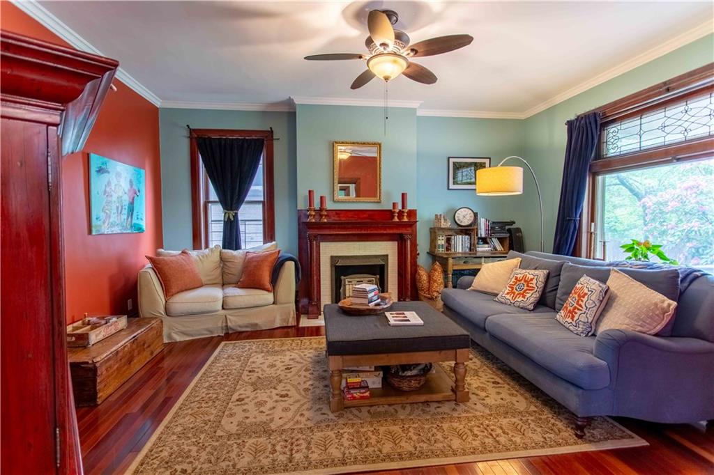 5901 Hampton Street Pittsburgh, PA 15206 - Photo 5 of 42 a living room with furniture a window and a fireplace