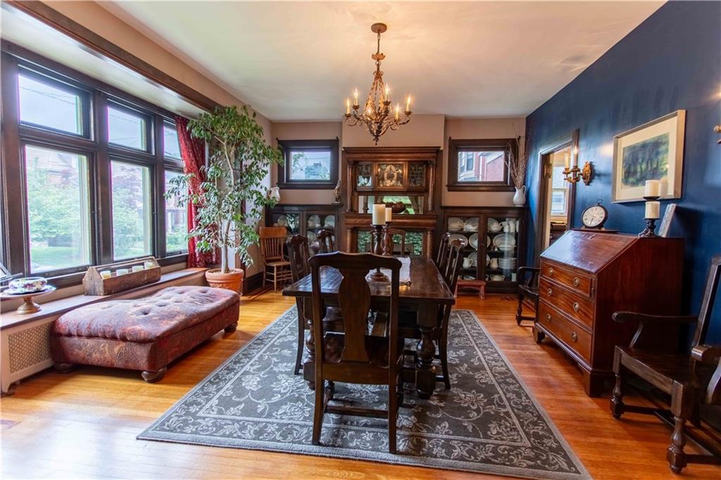 5901 Hampton Street Pittsburgh, PA 15206 - Photo 6 of 42 a living room with furniture a rug and a chandelier