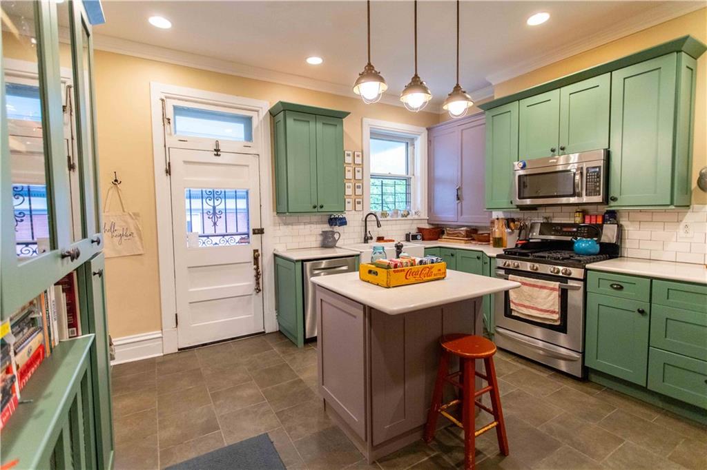 5901 Hampton Street Pittsburgh, PA 15206 - Photo 8 of 42 a kitchen with a sink stove and cabinets