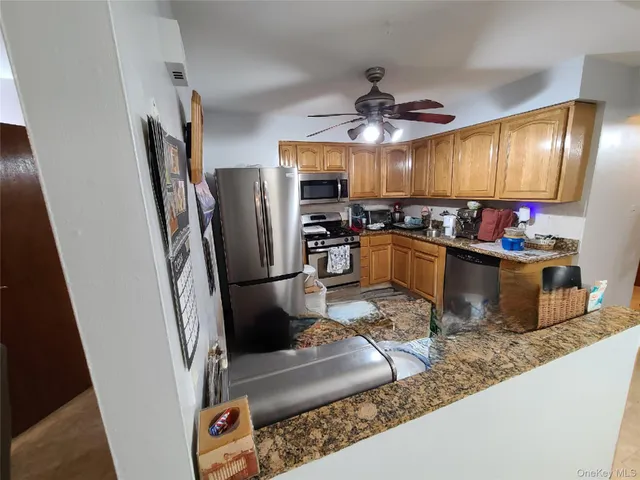 a kitchen with stainless steel appliances granite countertop a refrigerator a stove top oven a sink and dishwasher