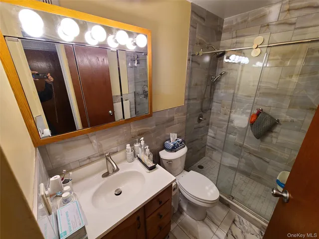 a bathroom with a sink mirror vanity and toilet