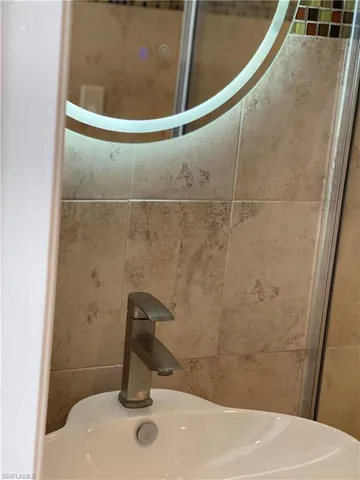 a kitchen with granite countertop cabinets stainless steel appliances and a window