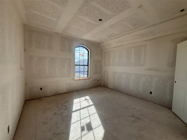 an empty room with a empty space and windows