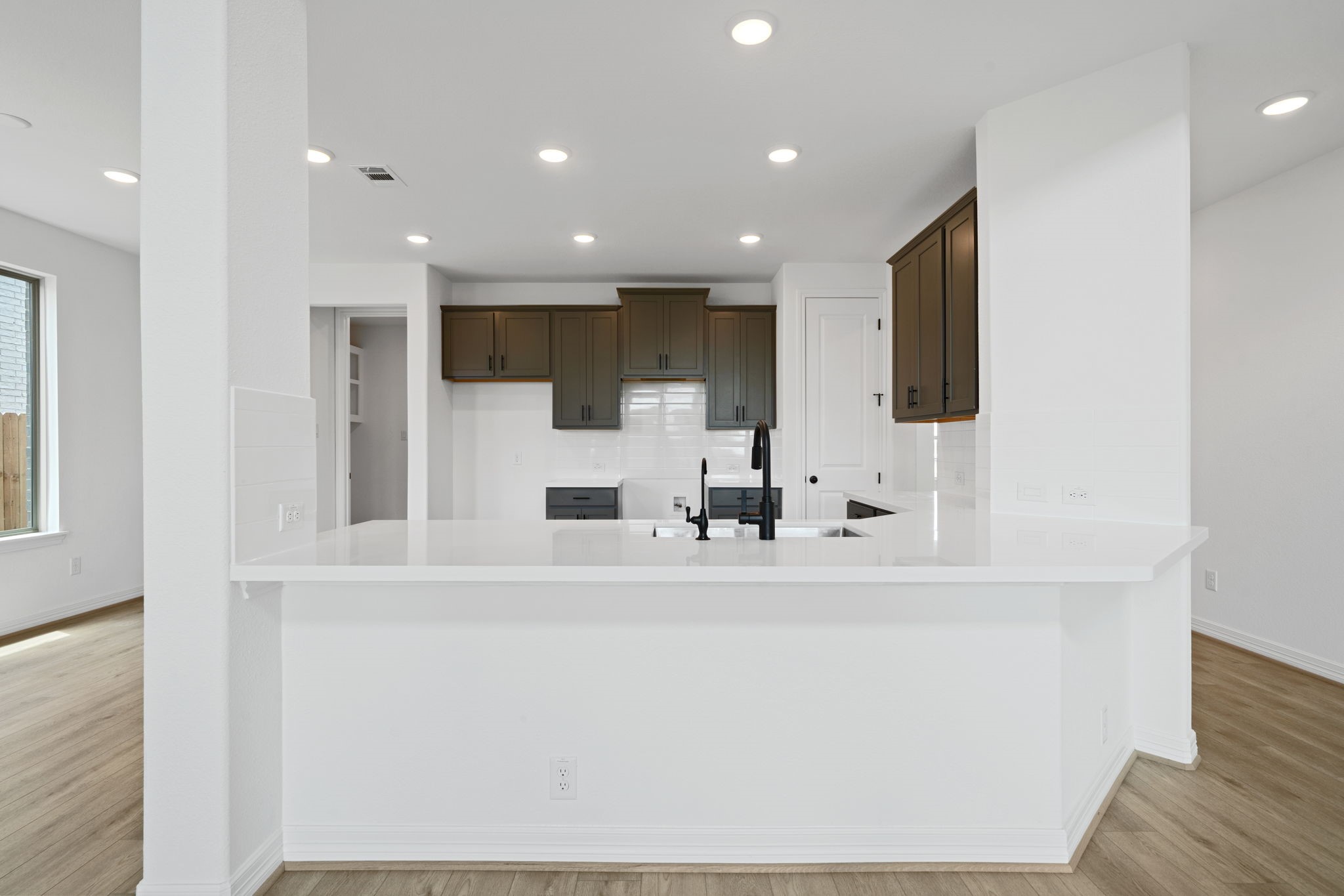 7826 Jasper Meadows Way Angleton, TX 77515 - Photo 7 of 34 a view of a kitchen with stainless steel appliances wooden floor and chair