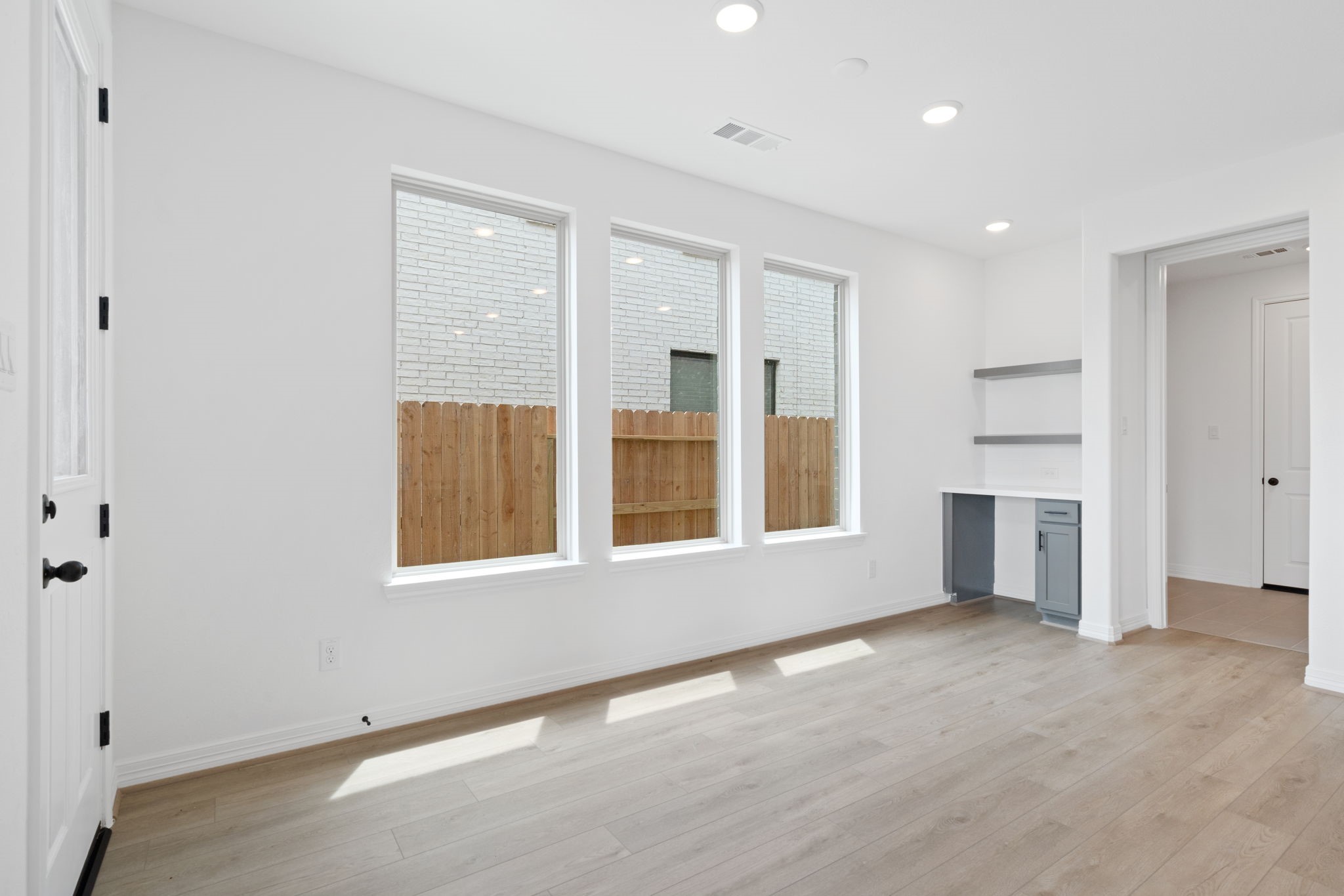 7826 Jasper Meadows Way Angleton, TX 77515 - Photo 8 of 34 wooden floor in an empty room with a window