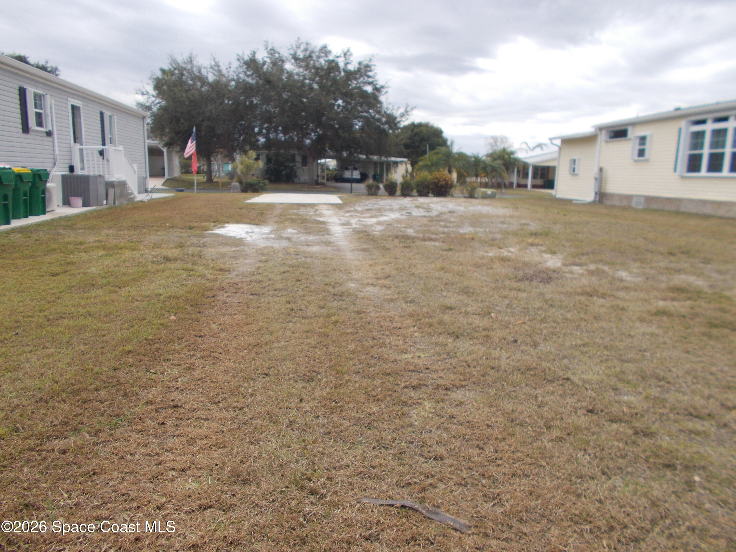 932 Fir Street Micco, FL 32976 - Photo 2 of 6 a view of road and trees