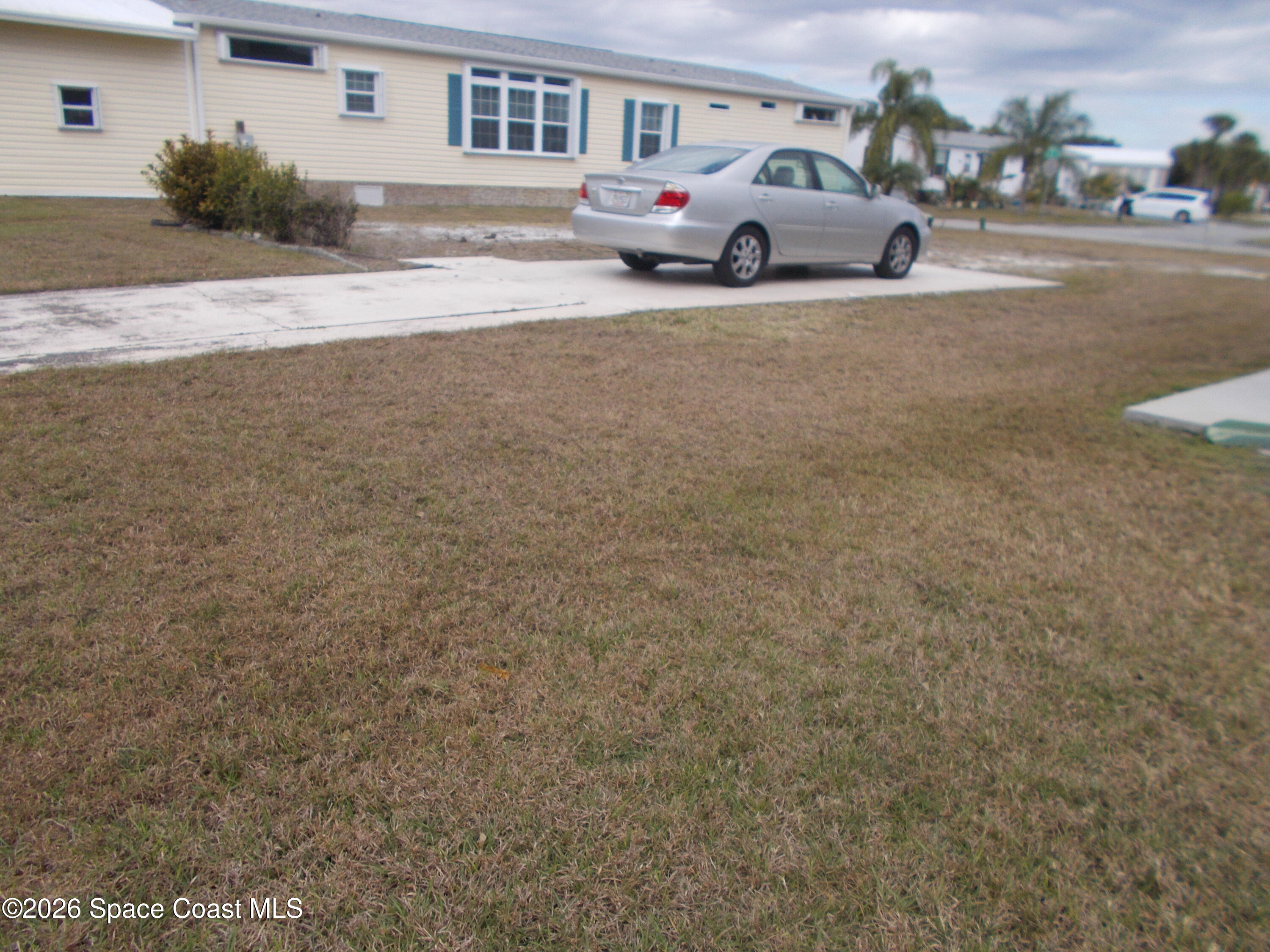 932 Fir Street Micco, FL 32976 - Photo 3 of 6 a front view of a house with a yard and garage