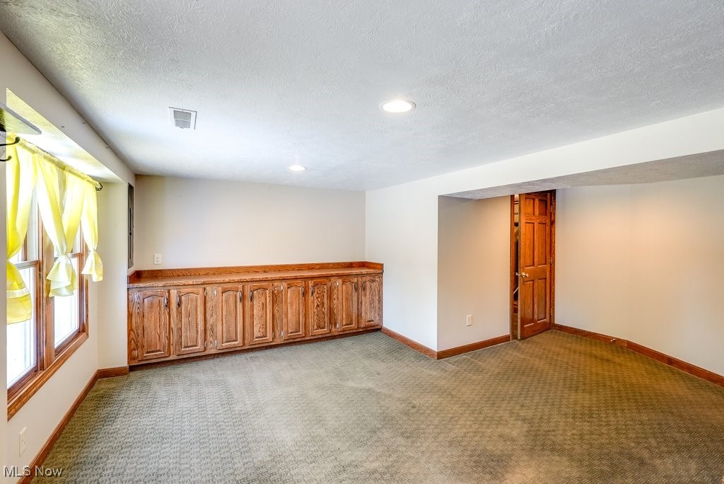 12802 Clinton Road Doylestown, OH 44230 - Photo 39 of 49 Spare room with light carpet and a textured ceiling