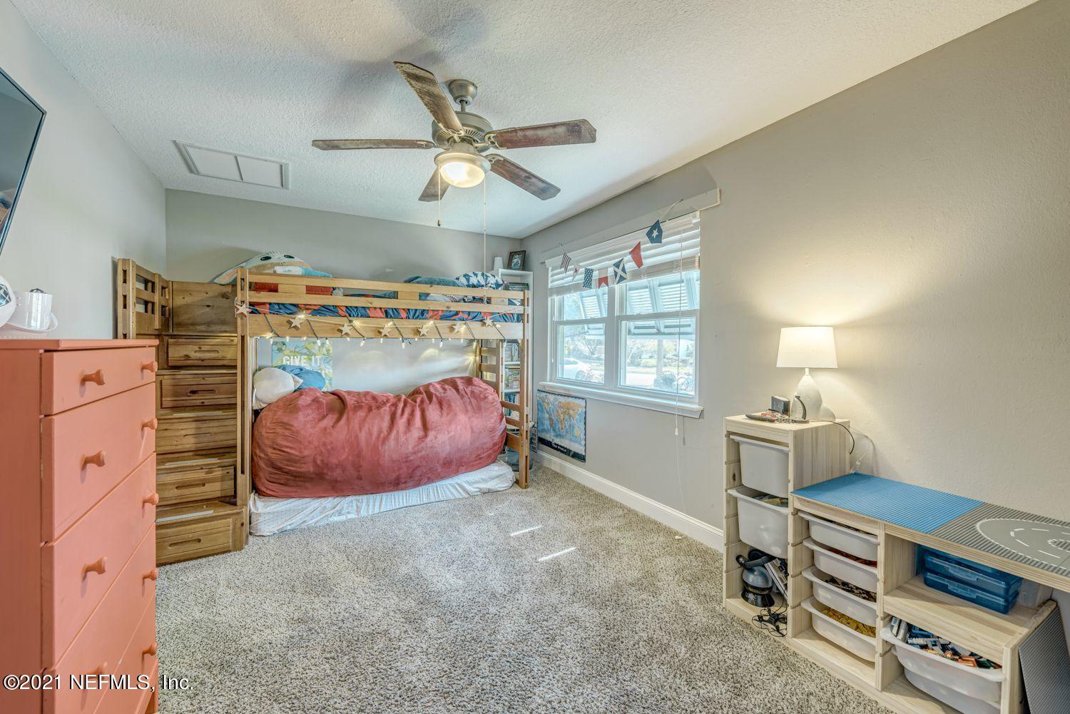 14443 Stacey Road Jacksonville, FL 32250 - Photo 11 of 16 a bed room with a bed and a window
