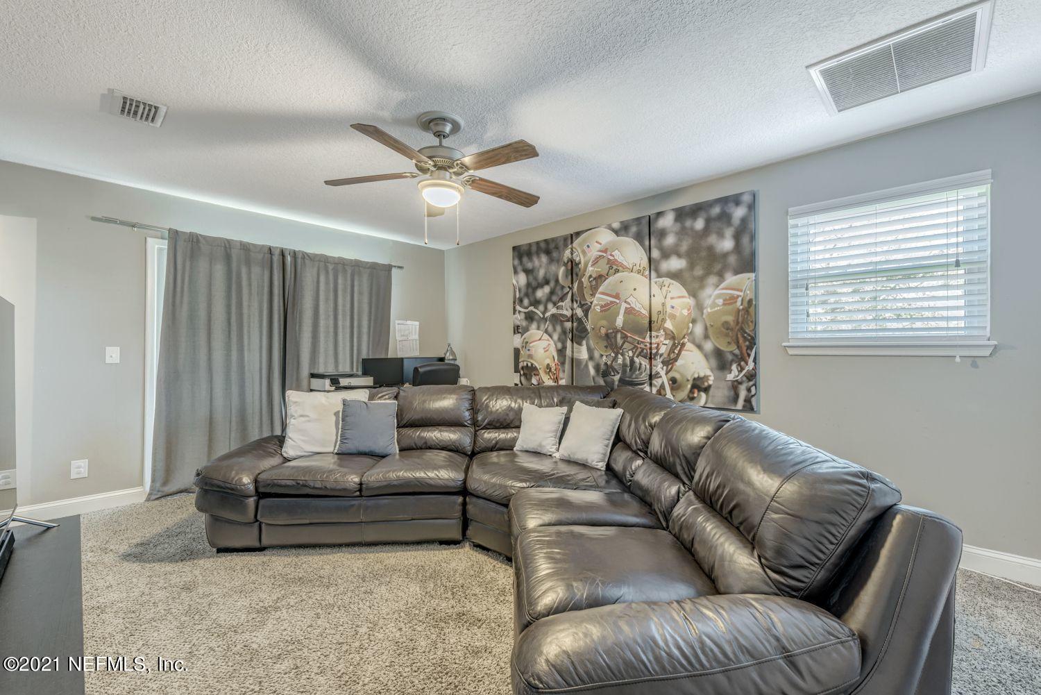 14443 Stacey Road Jacksonville, FL 32250 - Photo 12 of 16 a living room with furniture and a large window
