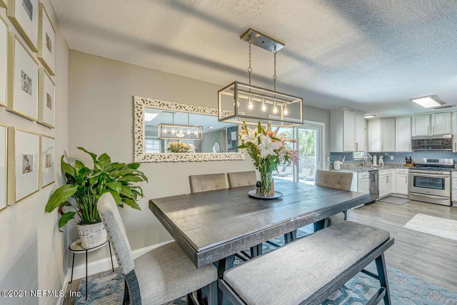14443 Stacey Road Jacksonville, FL 32250 - Photo 5 of 16 a view of a dining room with furniture window and wooden floor