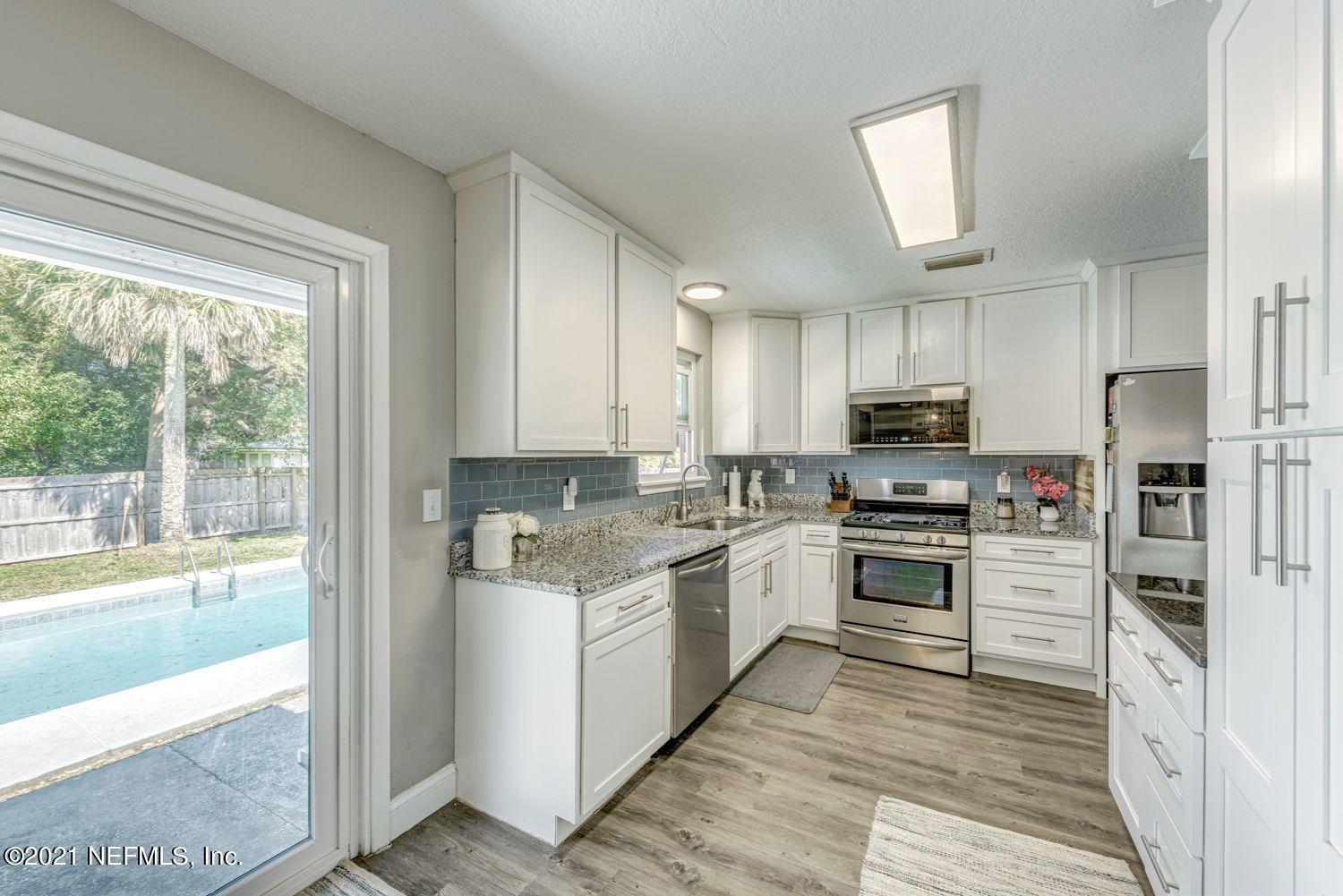 14443 Stacey Road Jacksonville, FL 32250 - Photo 6 of 16 a kitchen with stainless steel appliances granite countertop a stove top oven a sink and a refrigerator