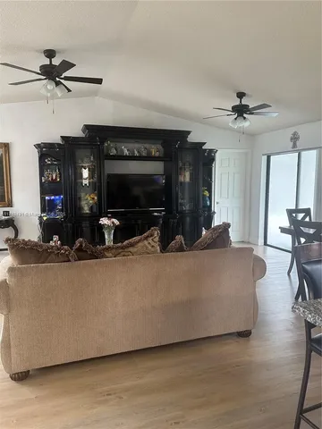 a kitchen with granite countertop a refrigerator stove microwave and sink