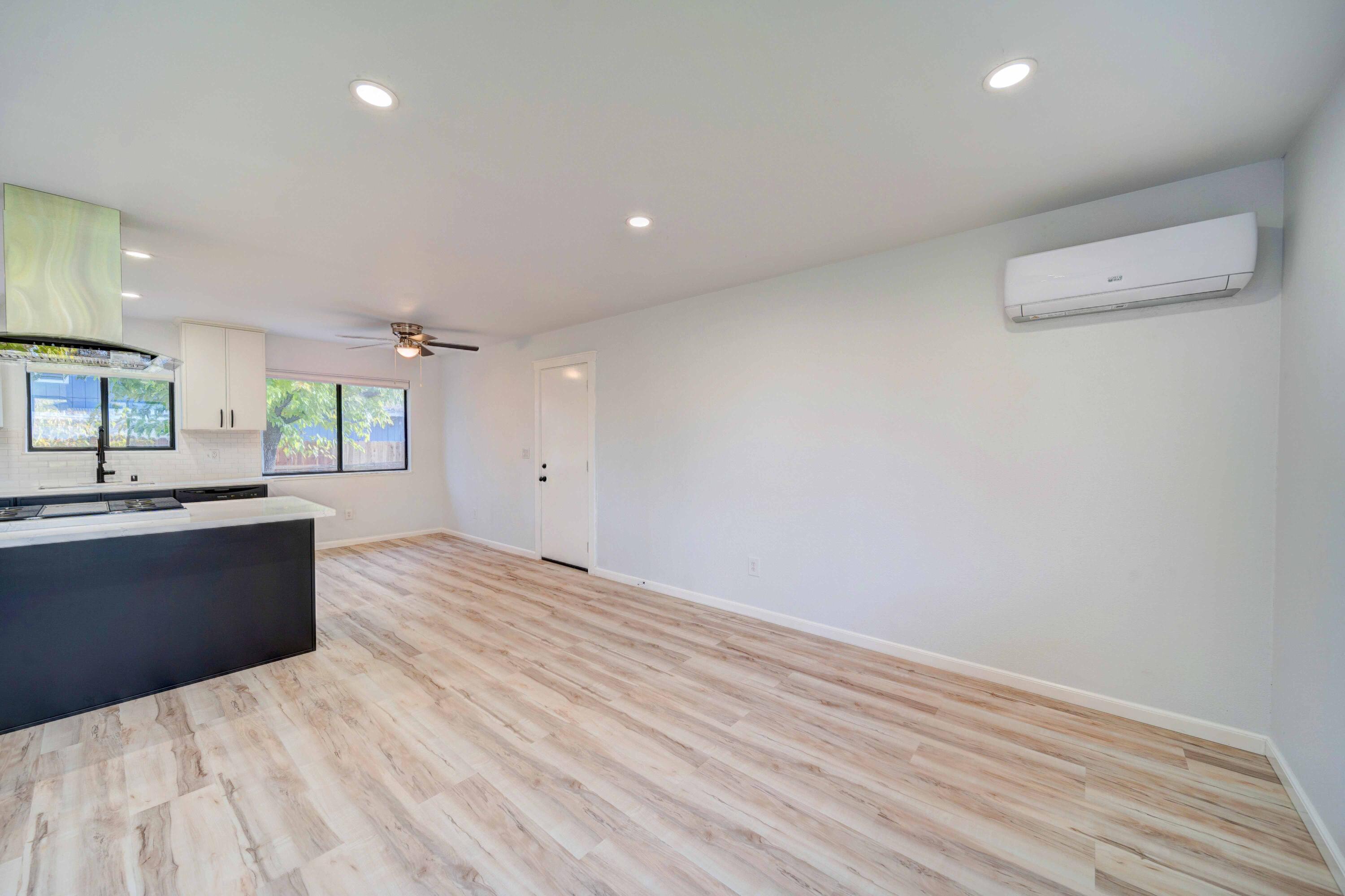 1611 2nd Street Anderson, CA 96007 - Photo 11 of 20 a view of a big room with wooden floor and windows