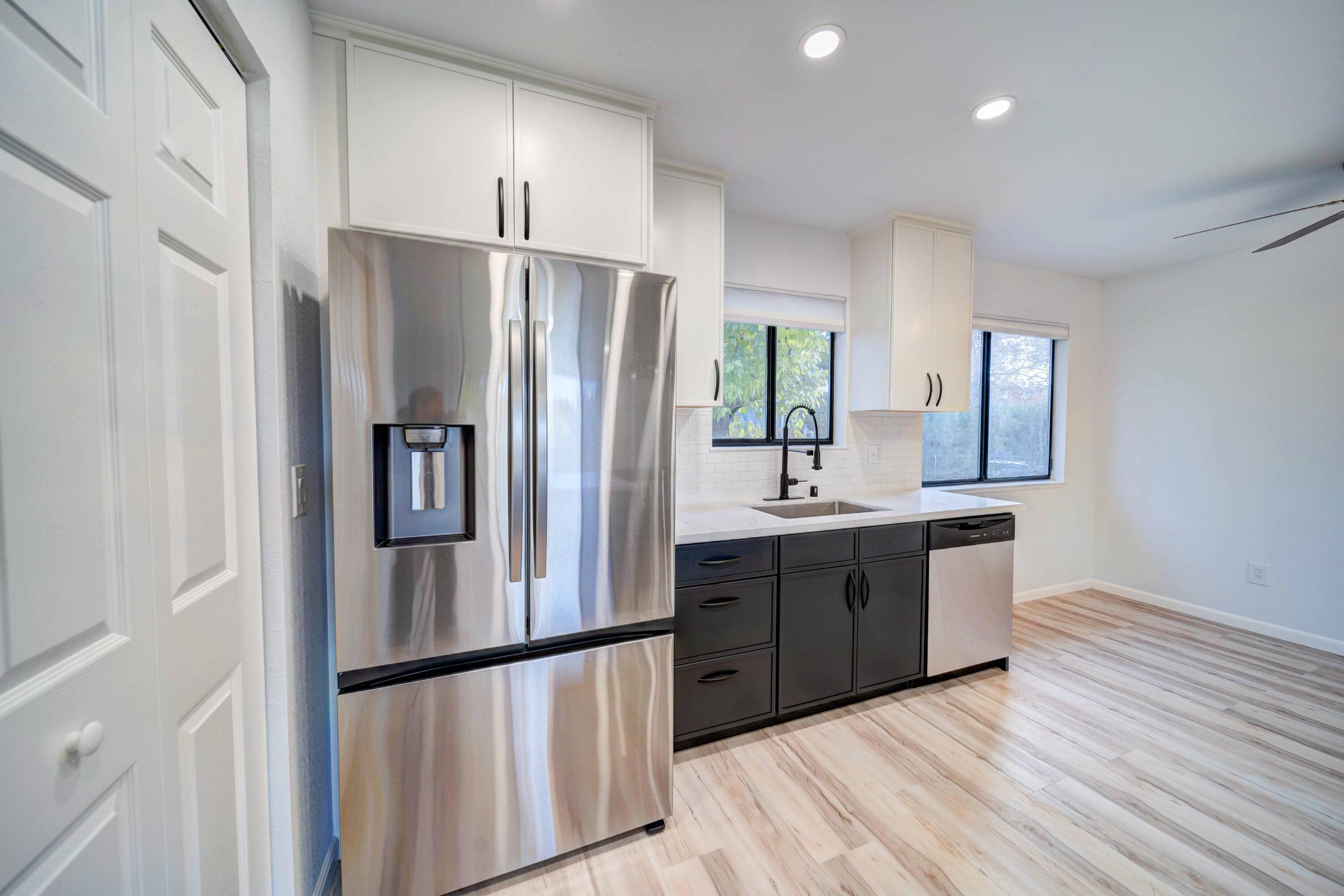 1611 2nd Street Anderson, CA 96007 - Photo 8 of 20 a kitchen with kitchen island a counter top space wooden floor and stainless steel appliances