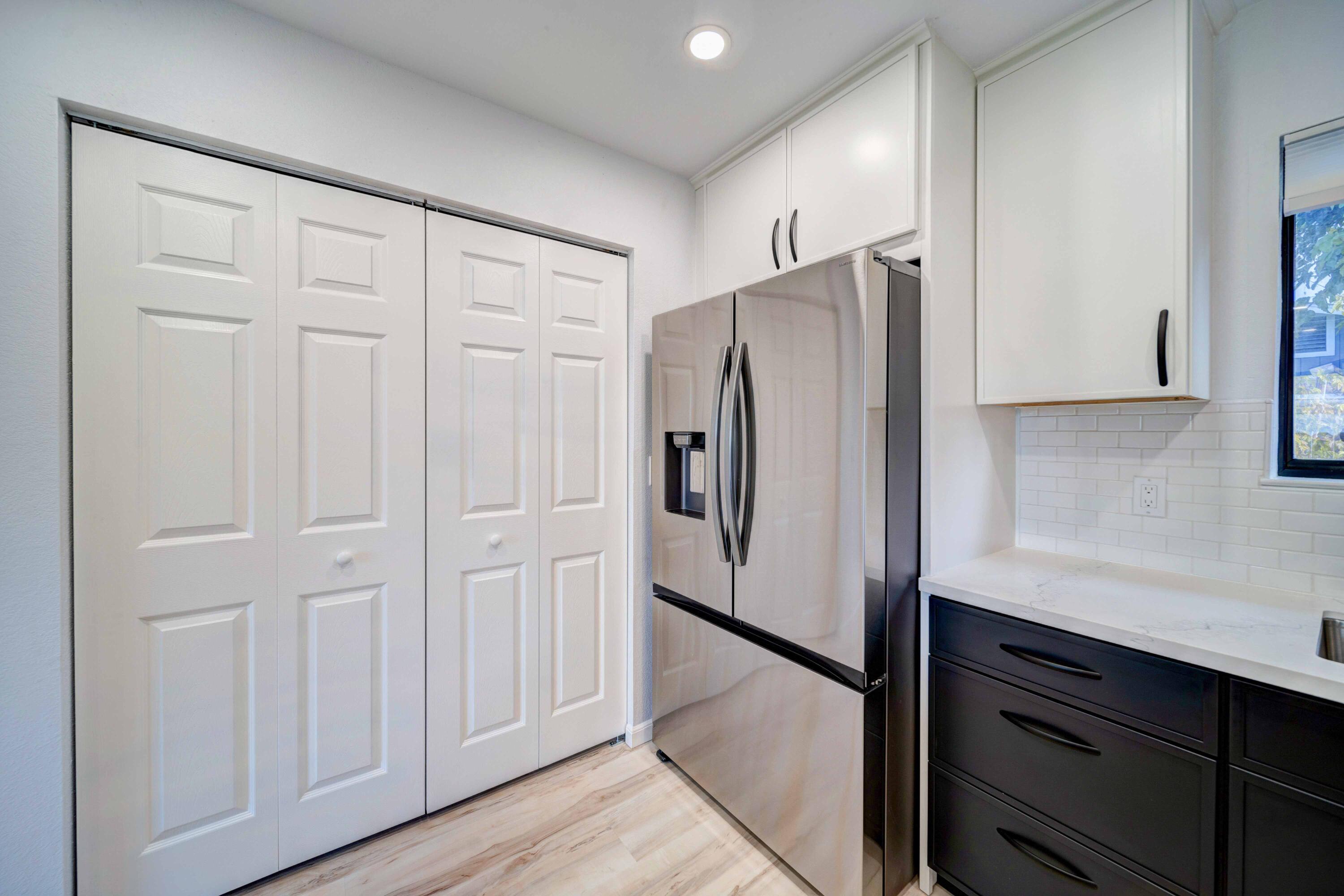 1611 2nd Street Anderson, CA 96007 - Photo 9 of 20 a view of a refrigerator in kitchen and white cabinets
