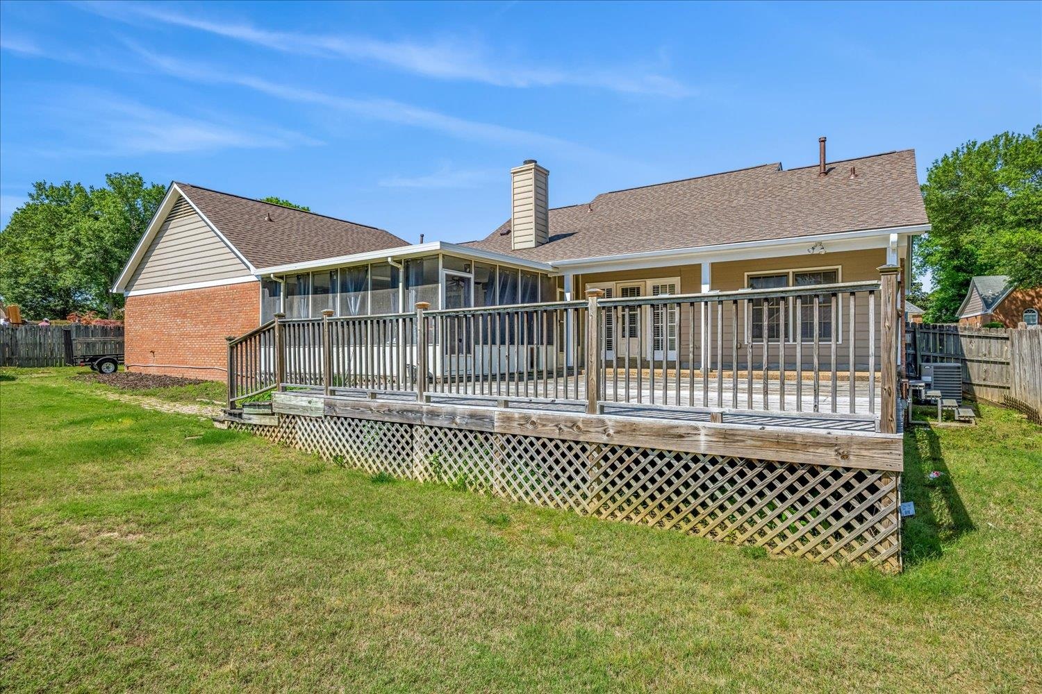 5128 Overview Ridge Memphis, TN 38141 - Photo 25 of 28 Expansive outdoor deck with lattice skirting and a screened-in porch