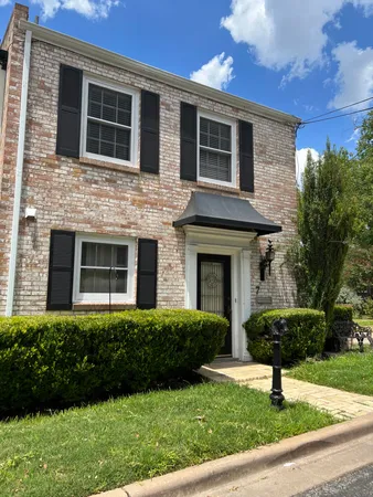 a front view of a house with yard and porch