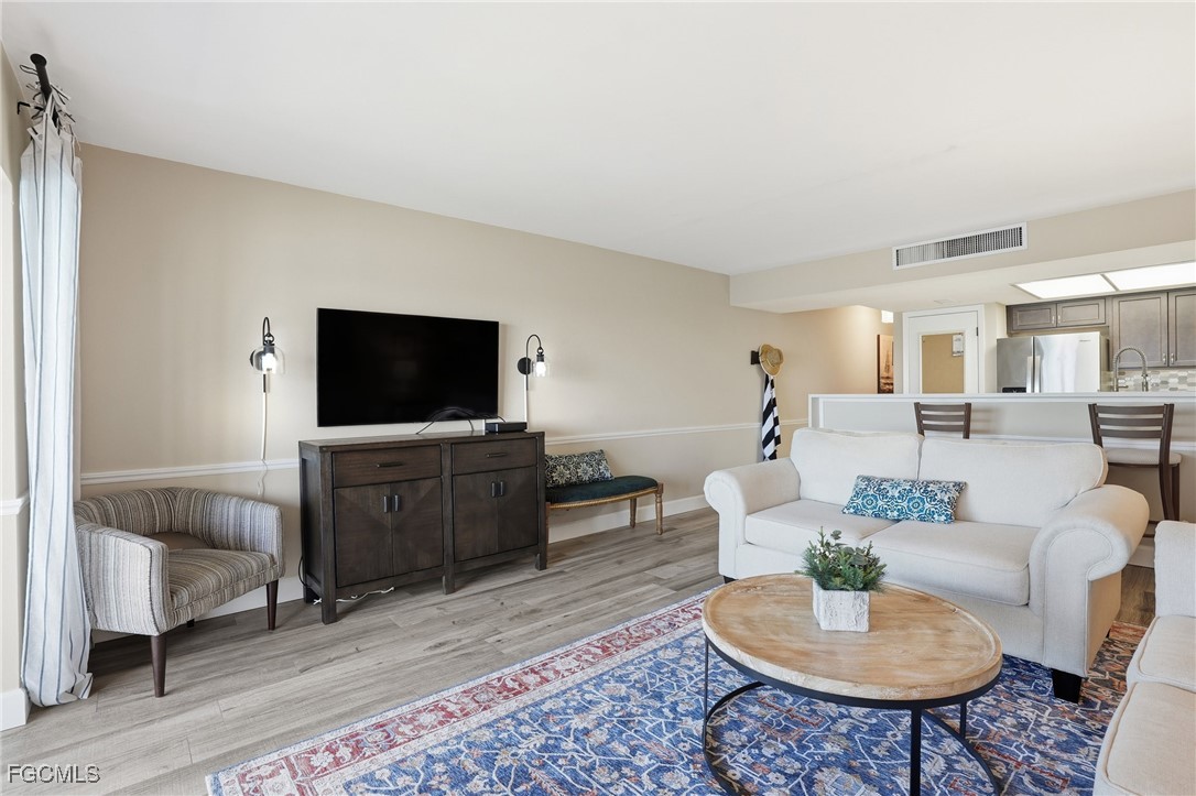 400 Lenell Road, Unit 706 Fort Myers Beach, FL 33931 - Photo 11 of 33 a living room with furniture and a flat screen tv