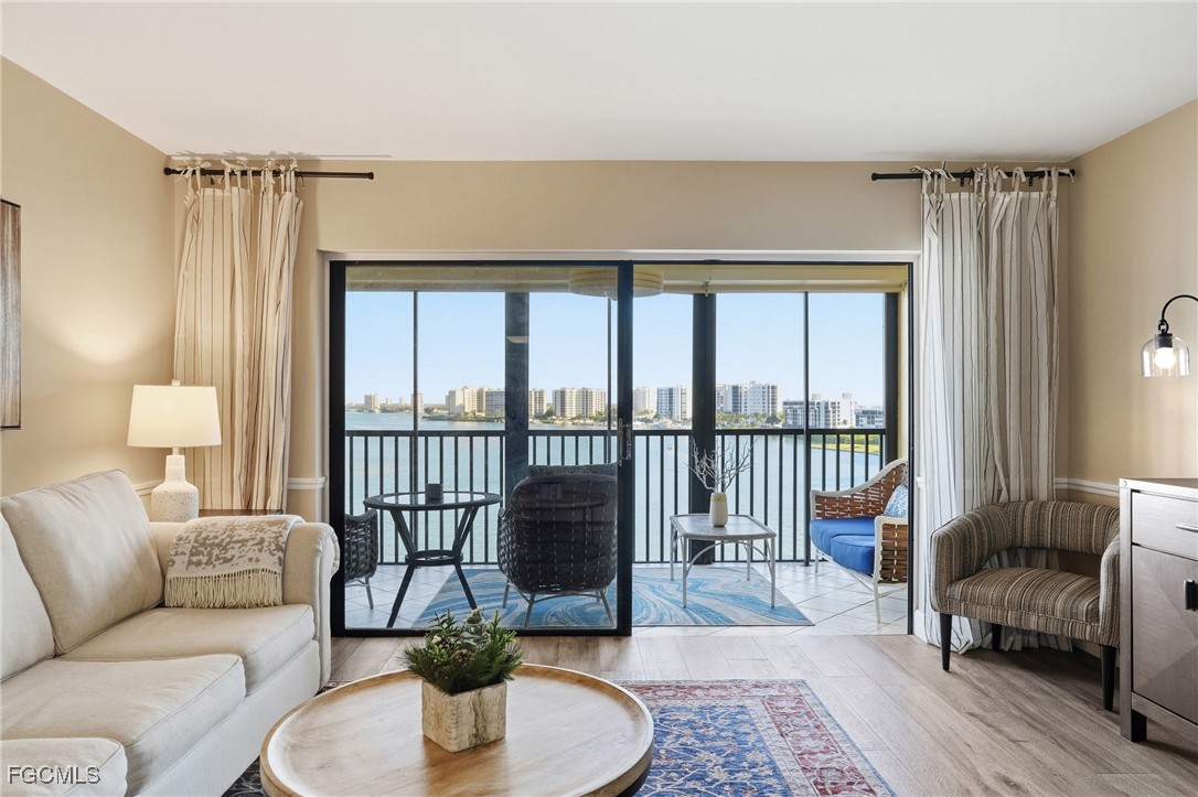 400 Lenell Road, Unit 706 Fort Myers Beach, FL 33931 - Photo 13 of 33 a living room with furniture and a floor to ceiling window