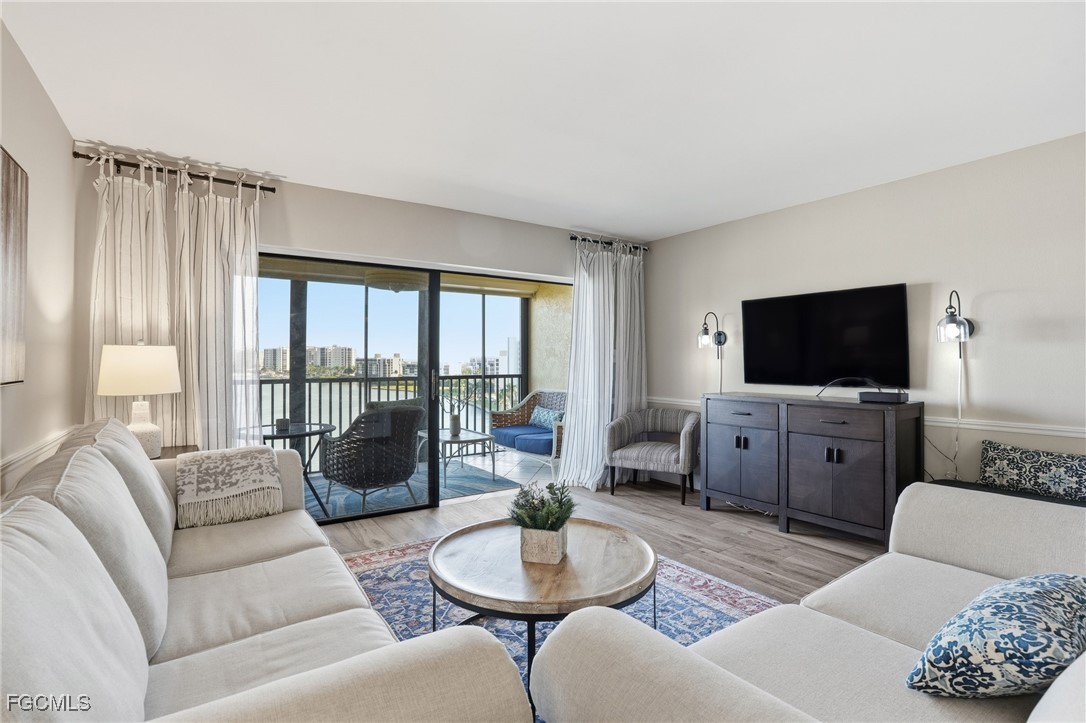 400 Lenell Road, Unit 706 Fort Myers Beach, FL 33931 - Photo 14 of 33 a living room with furniture and a flat screen tv