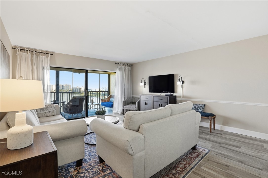 400 Lenell Road, Unit 706 Fort Myers Beach, FL 33931 - Photo 15 of 33 a living room with furniture and a flat screen tv