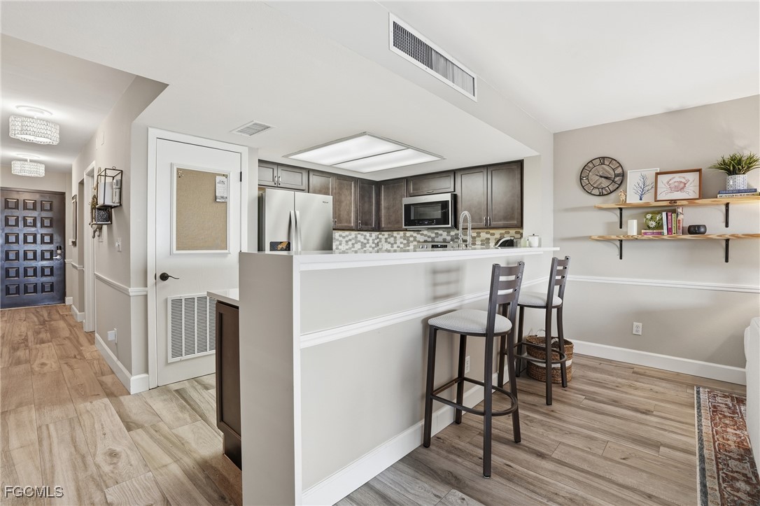 400 Lenell Road, Unit 706 Fort Myers Beach, FL 33931 - Photo 17 of 33 a view of kitchen with cabinets and wooden floor