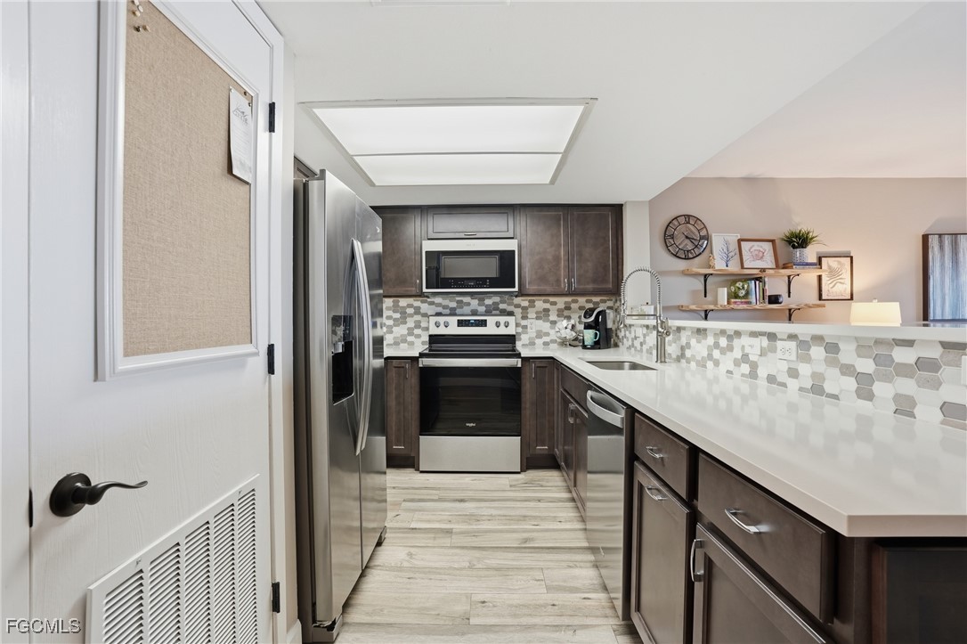 400 Lenell Road, Unit 706 Fort Myers Beach, FL 33931 - Photo 18 of 33 a kitchen with stainless steel appliances granite countertop a sink stove and refrigerator