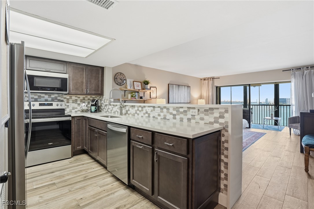 400 Lenell Road, Unit 706 Fort Myers Beach, FL 33931 - Photo 20 of 33 a kitchen with a stove and a refrigerator