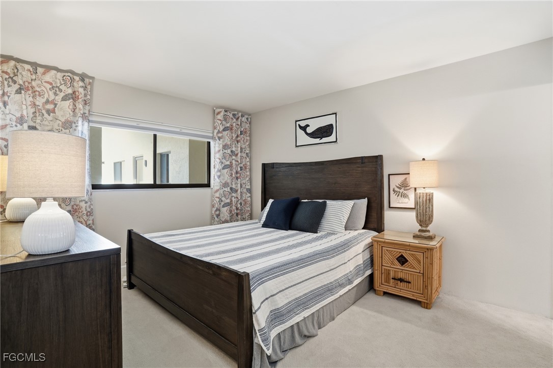 400 Lenell Road, Unit 706 Fort Myers Beach, FL 33931 - Photo 21 of 33 a bedroom with a bed and wooden floor