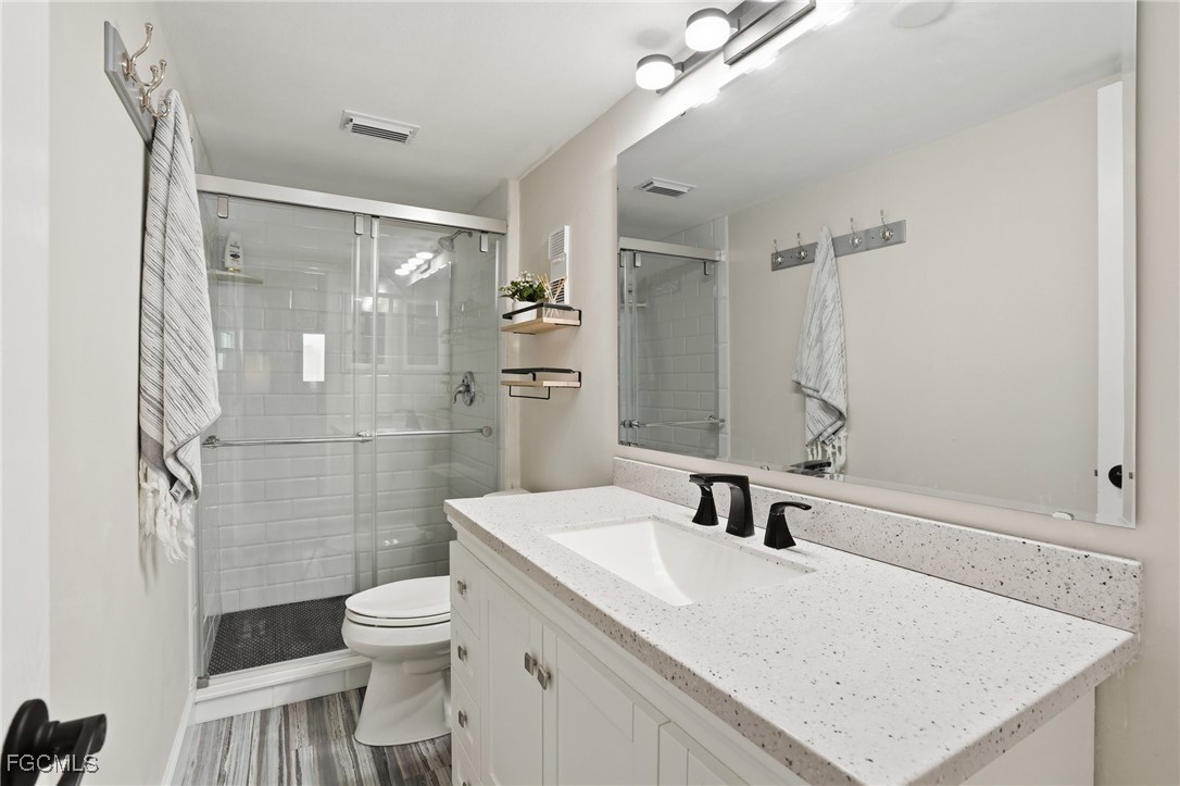 400 Lenell Road, Unit 706 Fort Myers Beach, FL 33931 - Photo 24 of 33 a bathroom with a sink toilet a mirror and shower