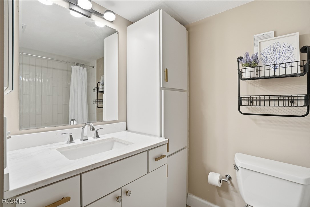 400 Lenell Road, Unit 706 Fort Myers Beach, FL 33931 - Photo 25 of 33 a bathroom with a sink toilet and a mirror