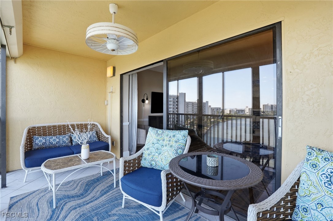 400 Lenell Road, Unit 706 Fort Myers Beach, FL 33931 - Photo 26 of 33 a living room with furniture and a floor to ceiling window
