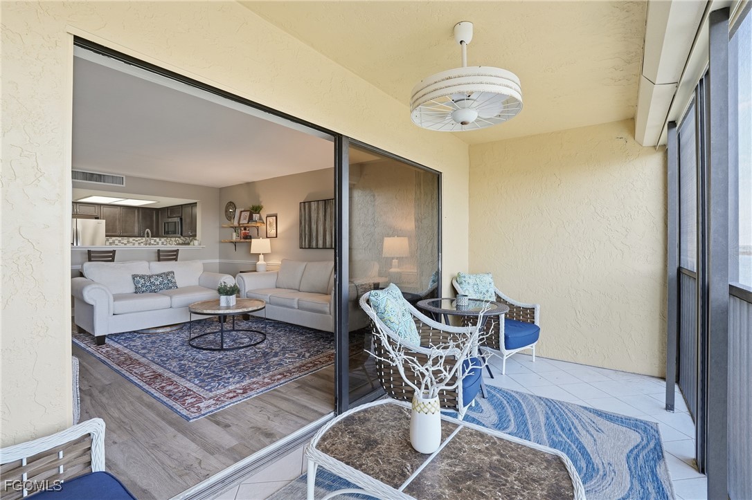 400 Lenell Road, Unit 706 Fort Myers Beach, FL 33931 - Photo 27 of 33 a living room with furniture and a chandelier