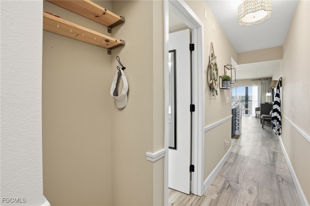 400 Lenell Road, Unit 706 Fort Myers Beach, FL 33931 - Photo 6 of 33 a hallway with white walls and wooden floor