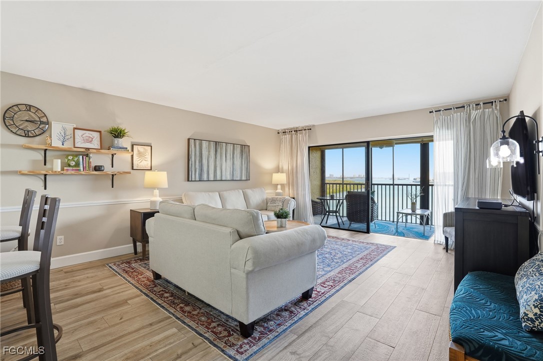 400 Lenell Road, Unit 706 Fort Myers Beach, FL 33931 - Photo 8 of 33 a living room with furniture and a large window