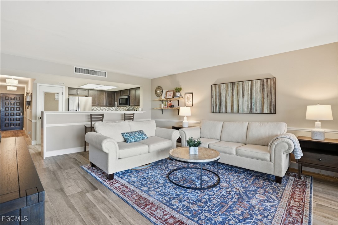 400 Lenell Road, Unit 706 Fort Myers Beach, FL 33931 - Photo 10 of 33 a living room with furniture and a rug
