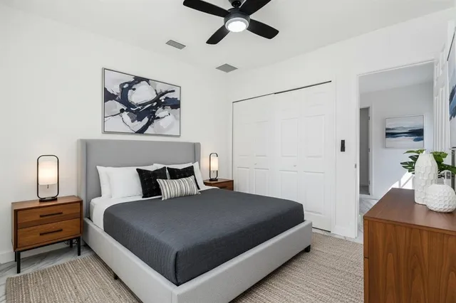 a bedroom with a bed and ceiling fan