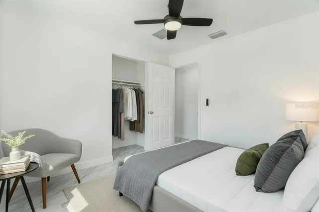 a bedroom with a bed and a chair