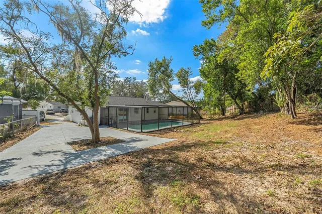a tree in front of a white house