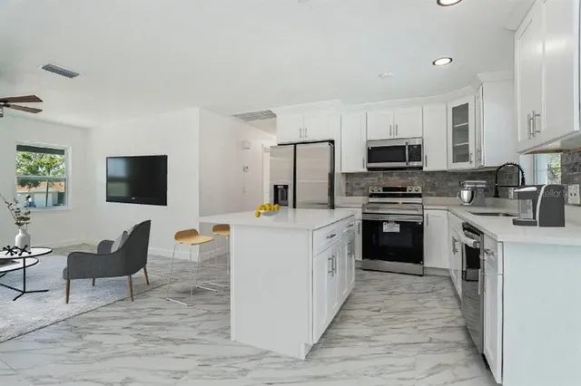 a kitchen with cabinets a sink and a stove top oven